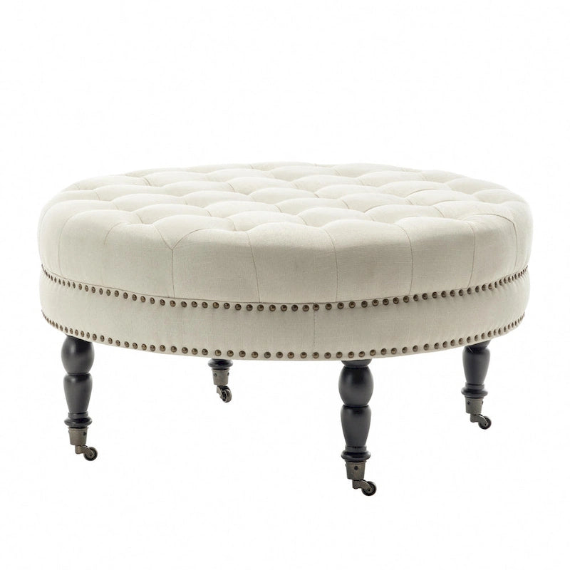 Pouf de cocktail rond en tissu Indy Porthos Home avec pieds et roulettes en bois d'hévéa