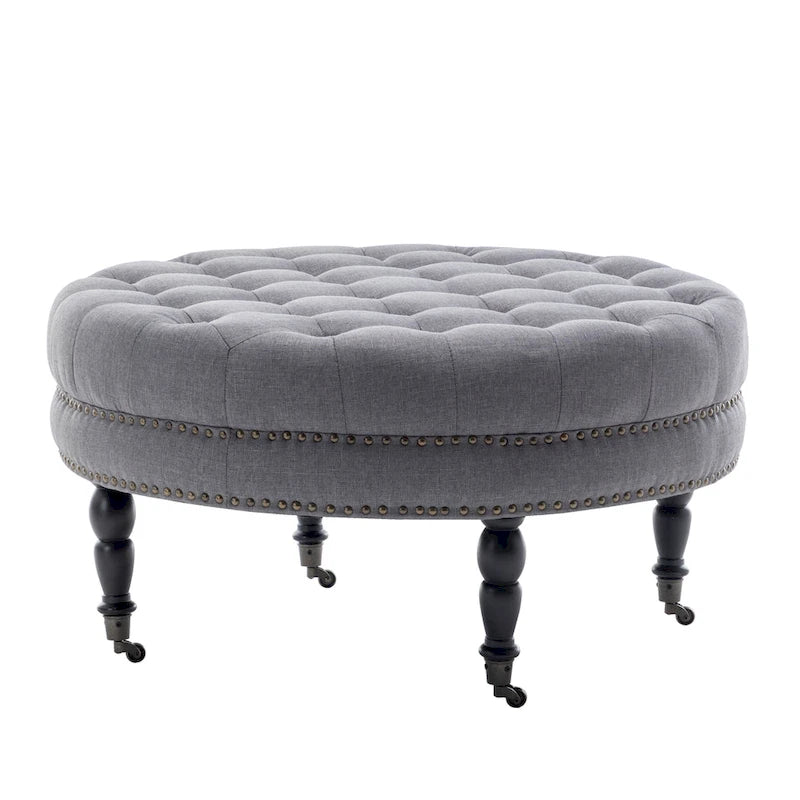 Pouf de cocktail rond en tissu Indy Porthos Home avec pieds et roulettes en bois d'hévéa
