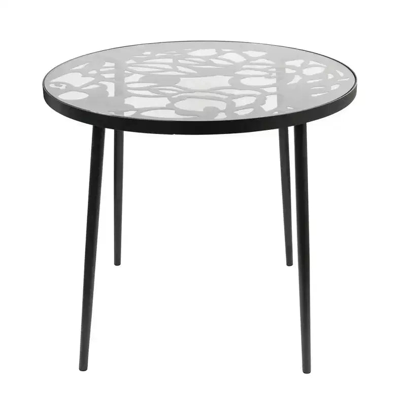 LeisureMod Devon Ensemble de salle à manger d'extérieur 5 pièces - Table ronde en verre avec 4 chaises empilables noires à motif floral