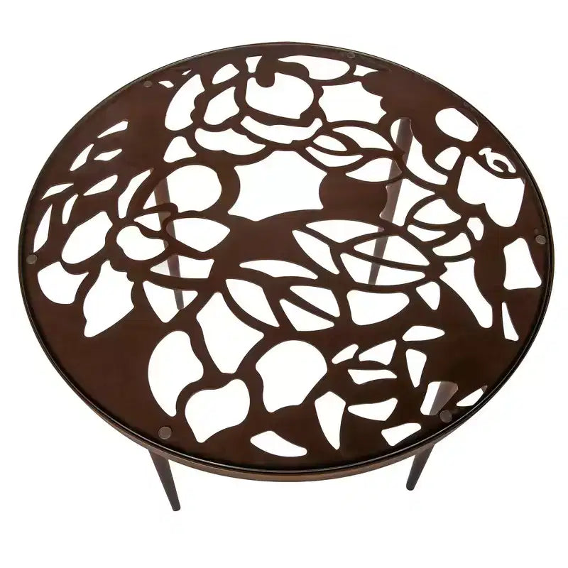 LeisureMod Devon Ensemble de salle à manger d'extérieur 5 pièces - Table ronde en verre avec 4 chaises empilables noires à motif floral