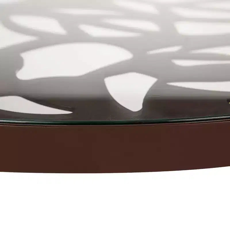 LeisureMod Devon Ensemble de salle à manger d'extérieur 5 pièces - Table ronde en verre avec 4 chaises empilables noires à motif floral