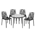 LeisureMod Devon 5-Piece Outdoor Dining Set - Round Glass Table with 4 Black Flower Design Stackable Chairs