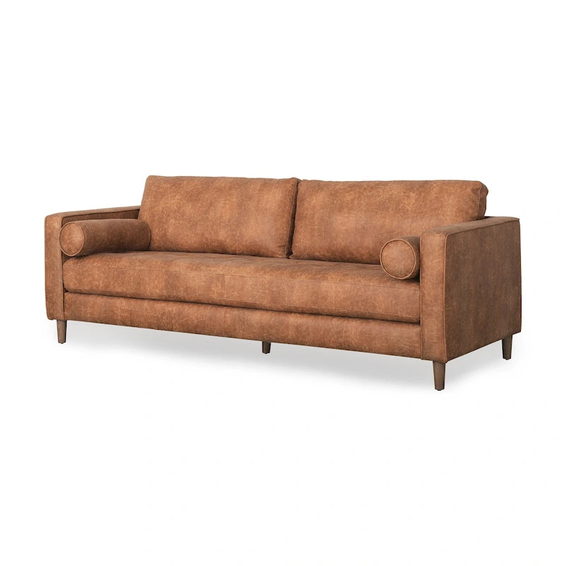Canapé trois places Loretta en similicuir marron cognac avec traversins – 223,3 L x 91,9 P x 85,9 H